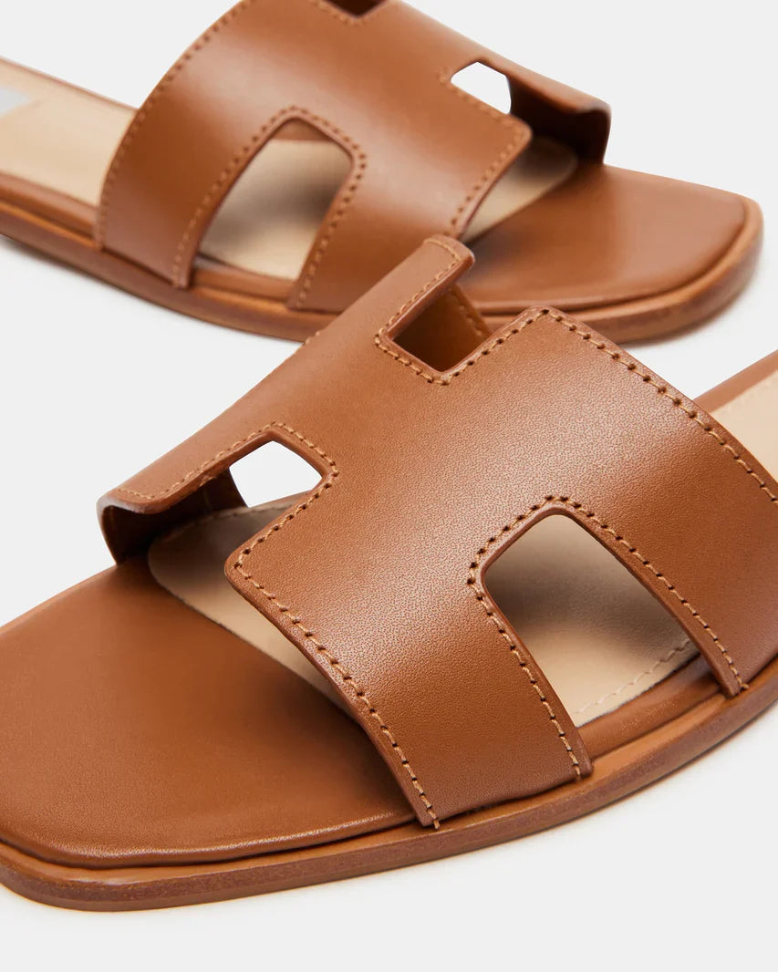 Cognac leather slide sandals close-up of stitched straps and open toe cutout