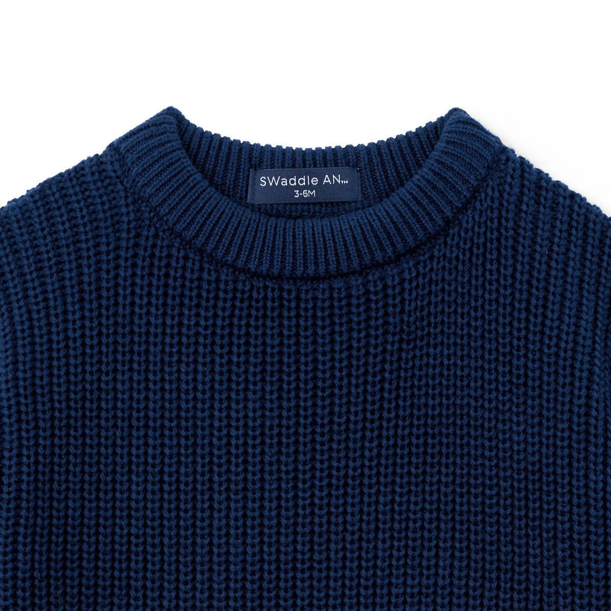 Navy chunky-knit baby romper neckline close-up with textured knit detail