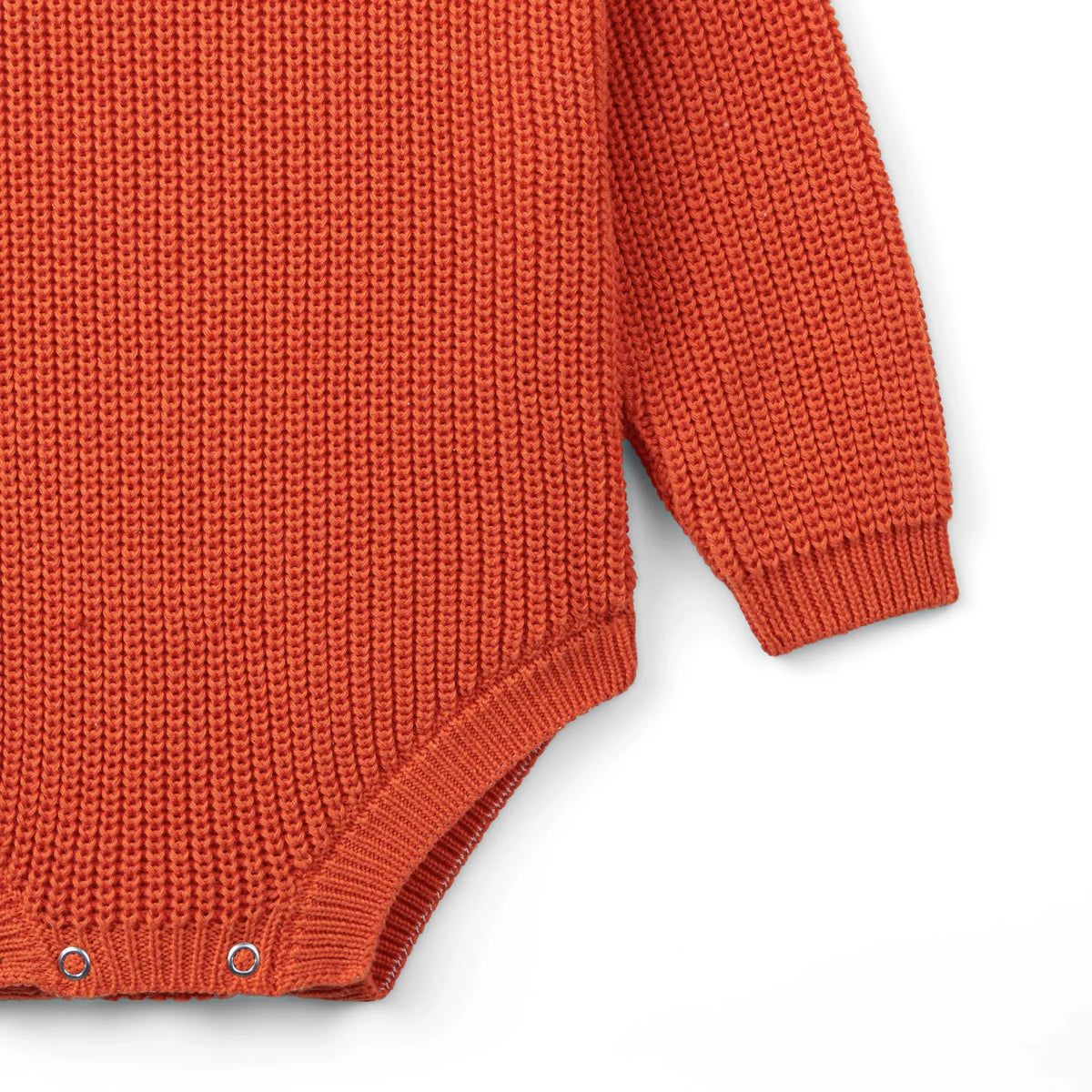 Orange rust chunky knit baby romper side view with snap buttons at the leg opening