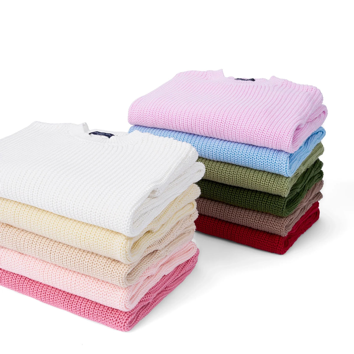 Stacked folded knit fabrics in multiple colors, including rose pink