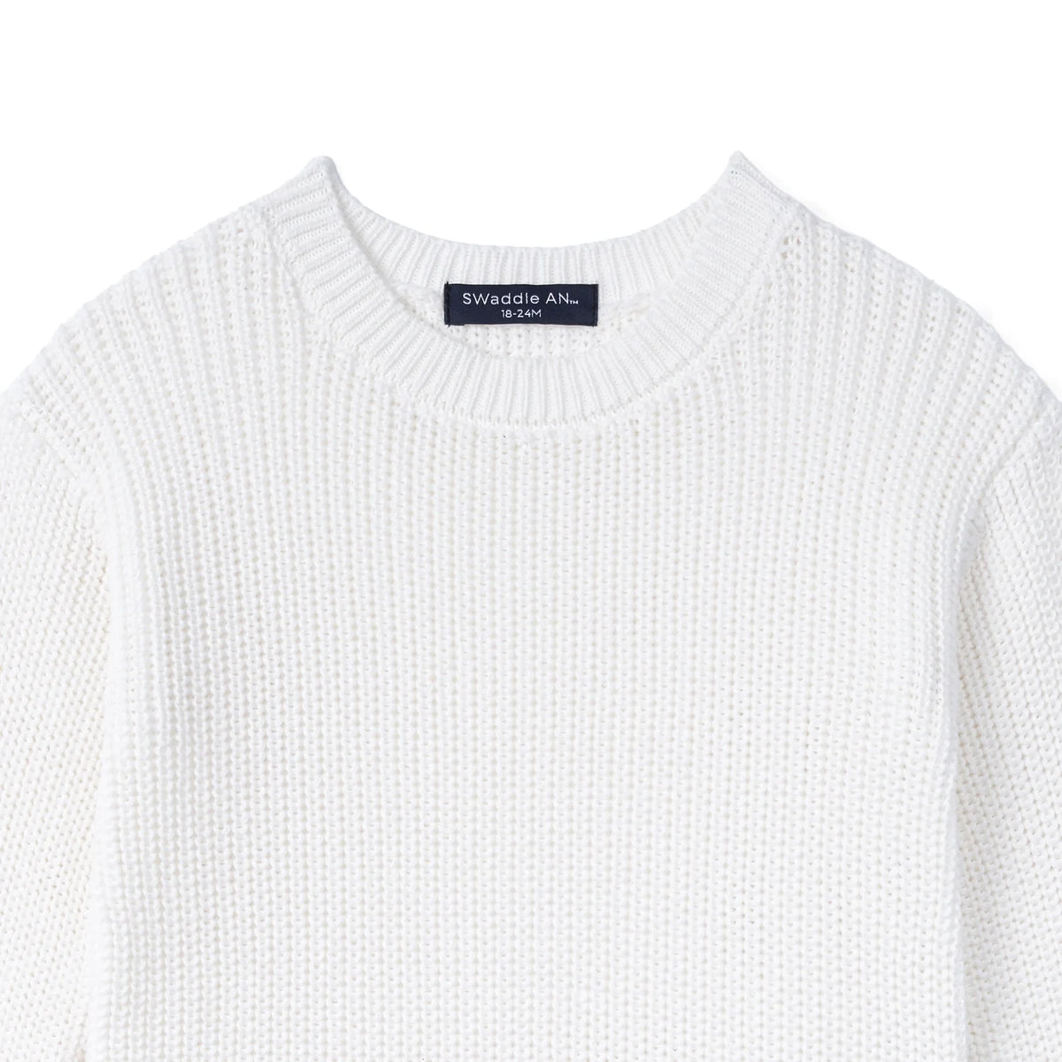 White knit baby romper with crew neckline and brand label at collar