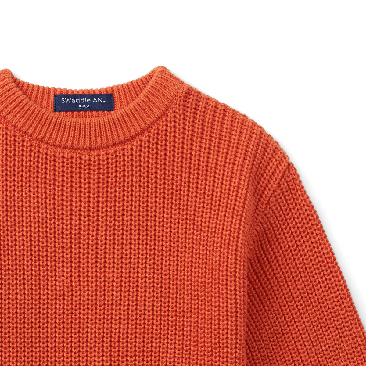 Orange-rust knit baby romper neckline and shoulder seam detail