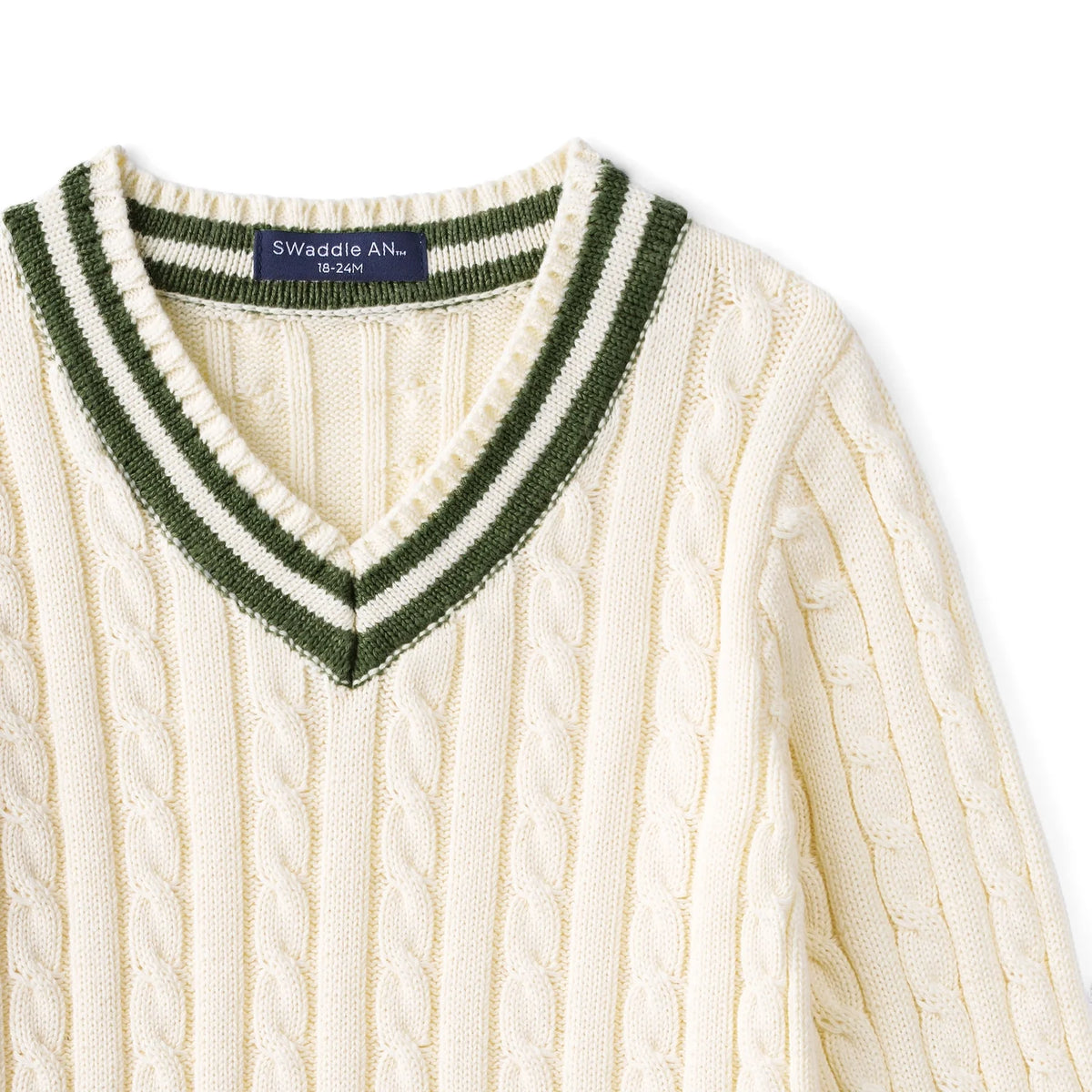 Kids cable knit cricket sweater close-up of cream V-neck with green stripe collar trim