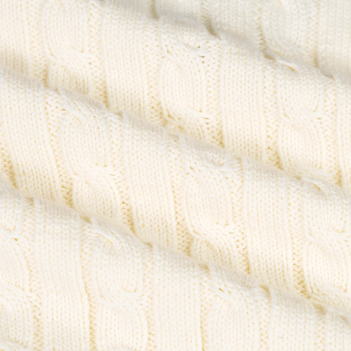 Cream cable knit texture detail on kids cricket sweater knit fabric