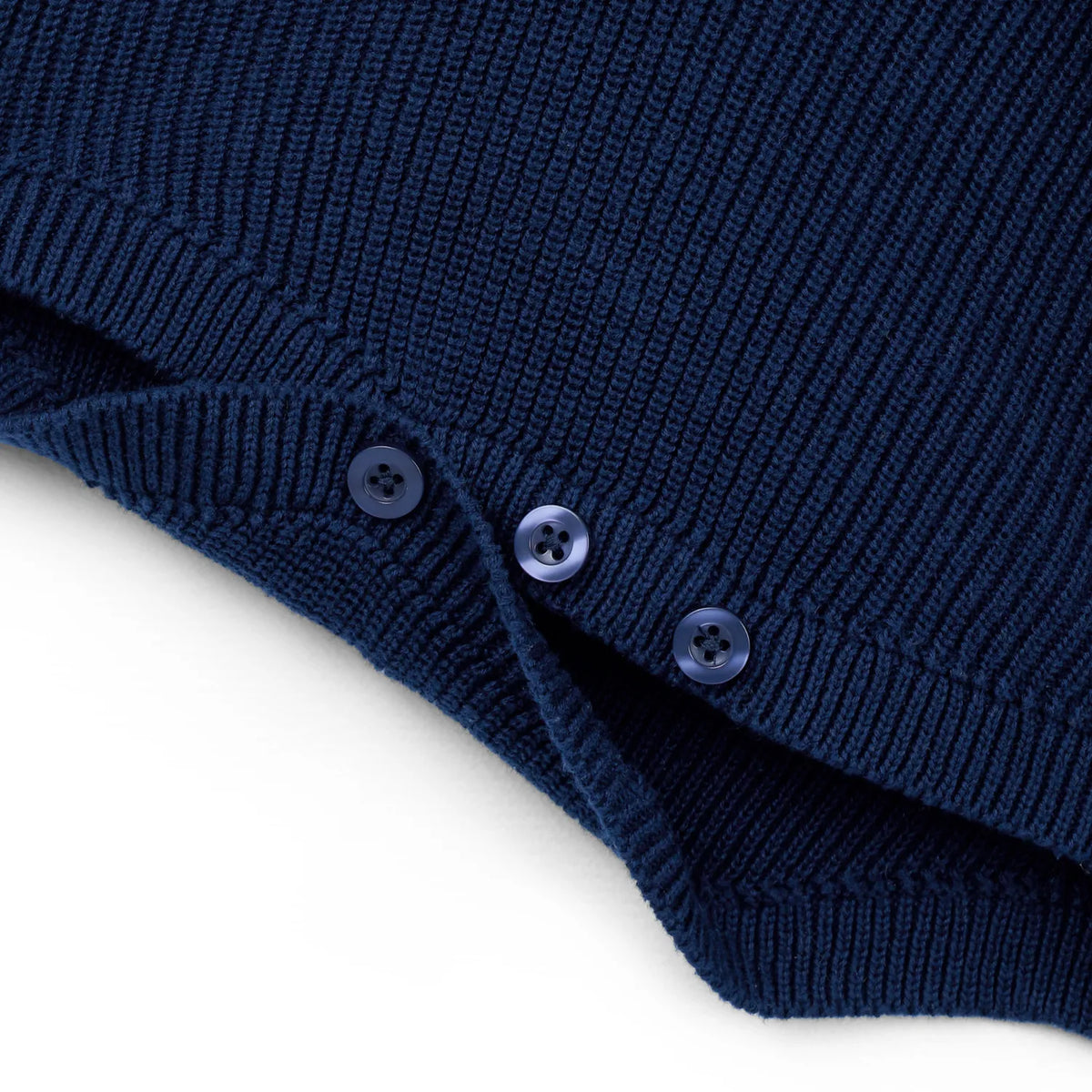 Navy knit romper hem with three button snaps on leg