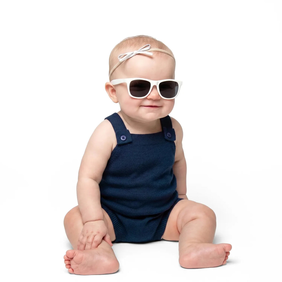 Navy knit baby romper with button straps, sleeveless fit