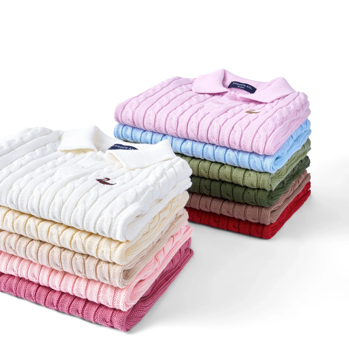 Stack of cable knit polo sweaters in red, white, pink, light blue, and green