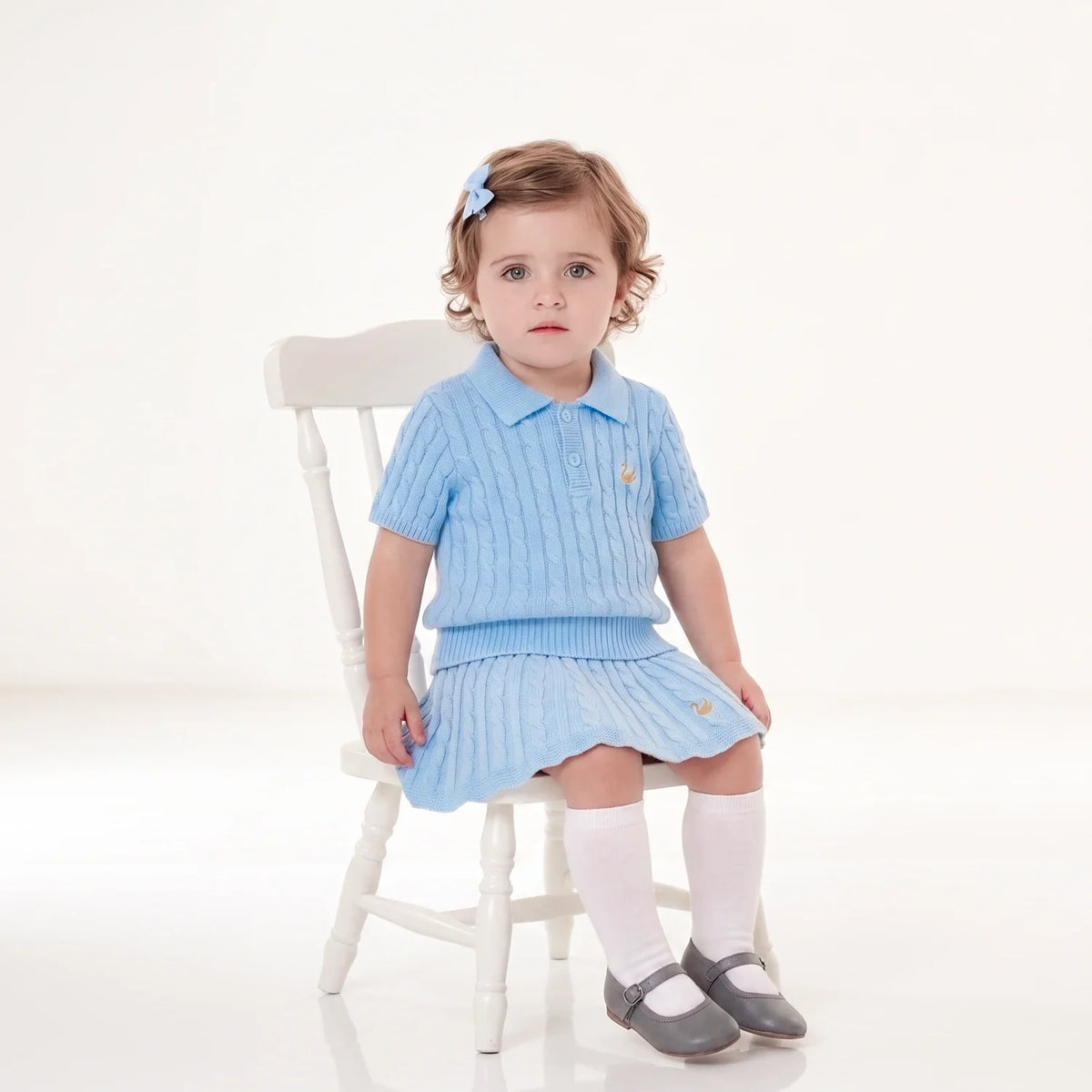 Baby blue cable knit skirt on child, ribbed waistband and flared knit hem
