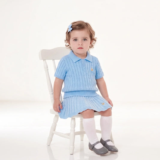 Baby blue cable knit skirt on child, ribbed waistband and flared knit hem