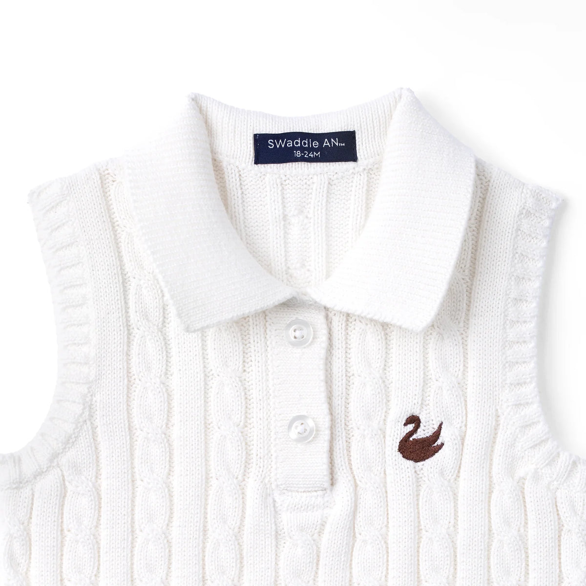 White cable-knit sleeveless polo shirt closeup, ribbed collar, button placket, bird logo