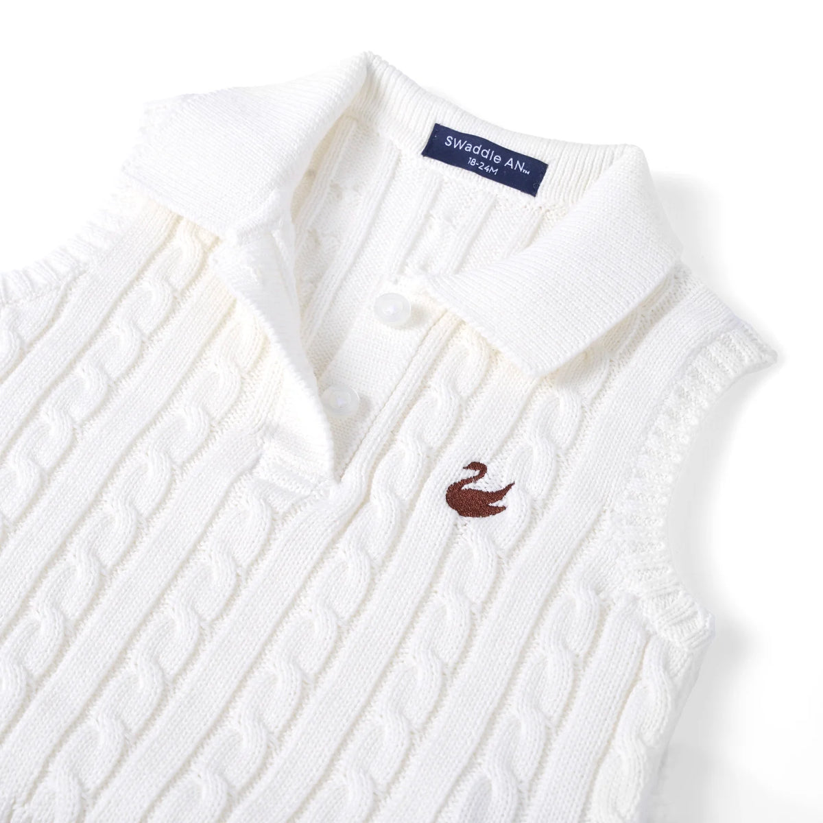 White cable-knit sleeveless polo shirt closeup, collar and bird logo on chest