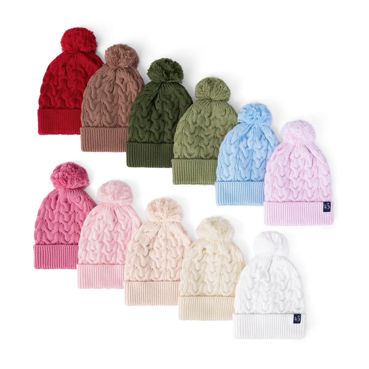 Assorted kids cable knit pom beanies with pom-poms and ribbed cuffs in multiple colors.