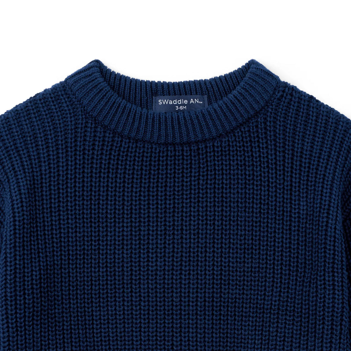 Navy knit baby sweater close-up of crew neckline and textured stitch pattern