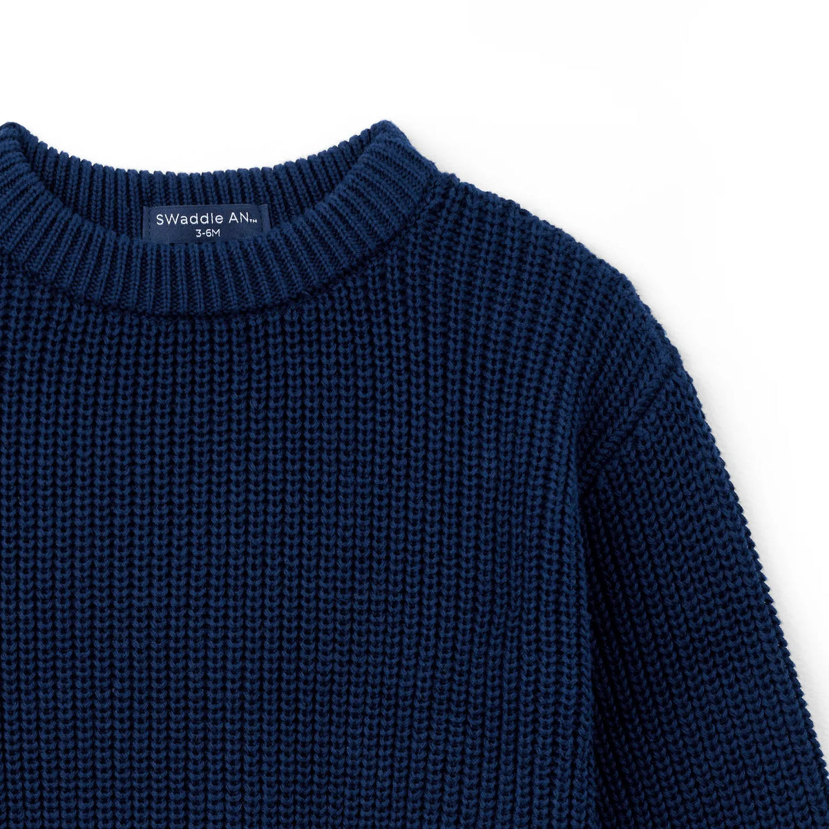 Navy knit baby sweater with ribbed crew neck collar and textured body knit