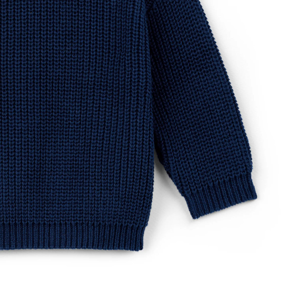 Navy knit baby sweater sleeve with ribbed cuff and ribbed hem edge
