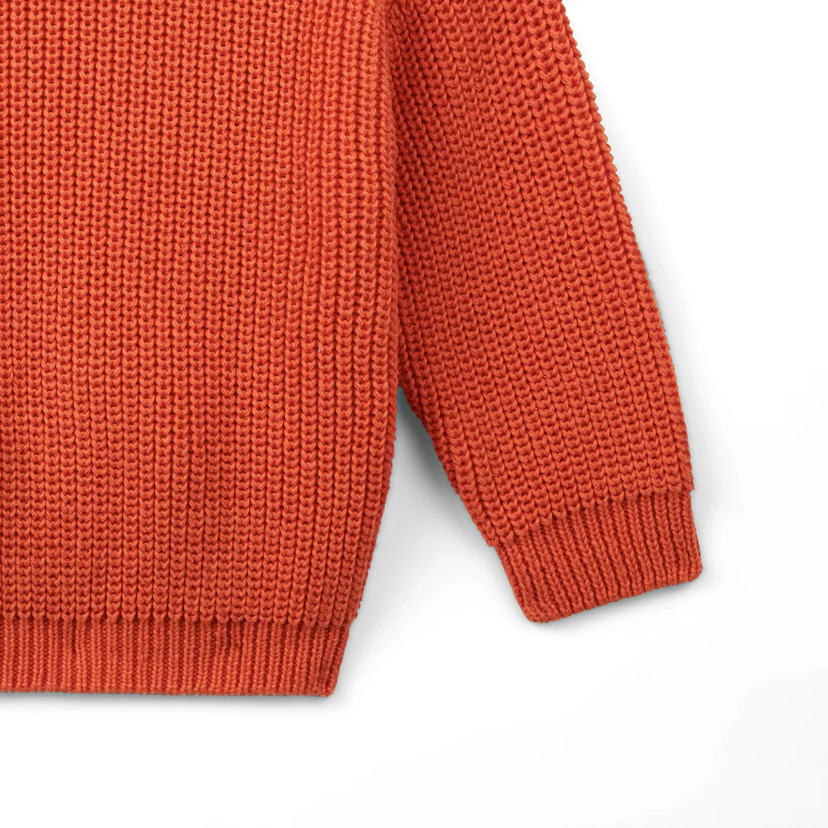 Orange rust knit baby sweater with ribbed hem and sleeve cuffs