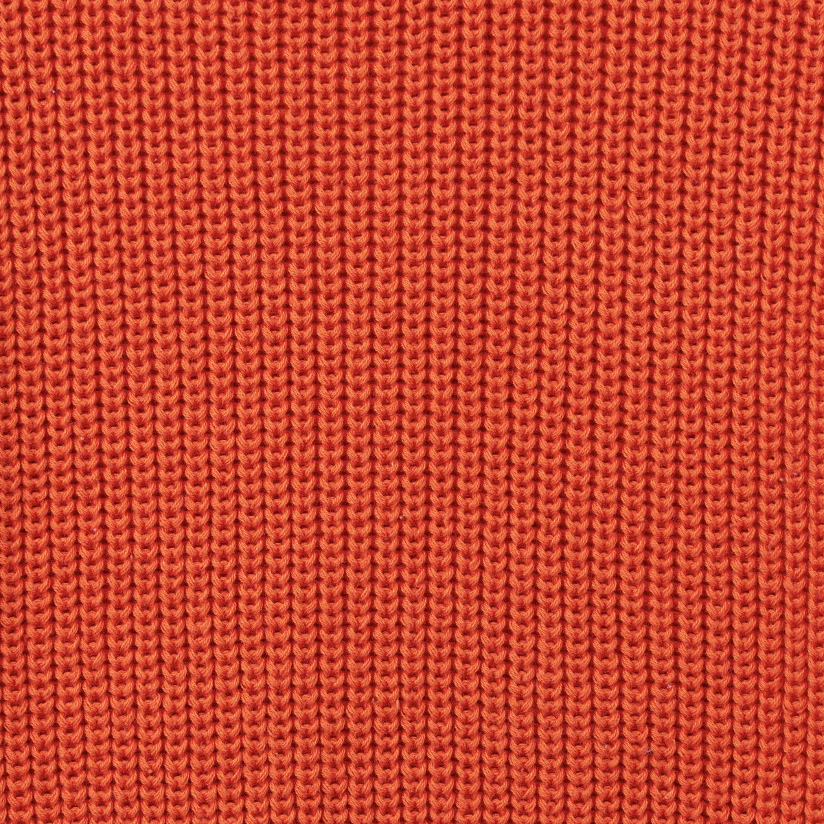 Orange rust knitted sweater fabric texture close-up