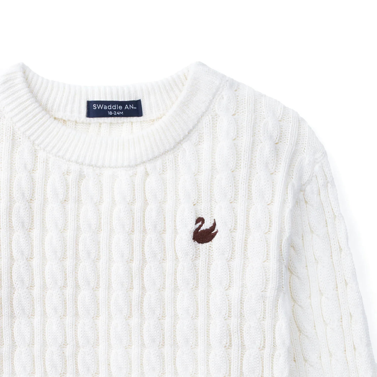 White cable knit baby sweater with embroidered chest logo detail