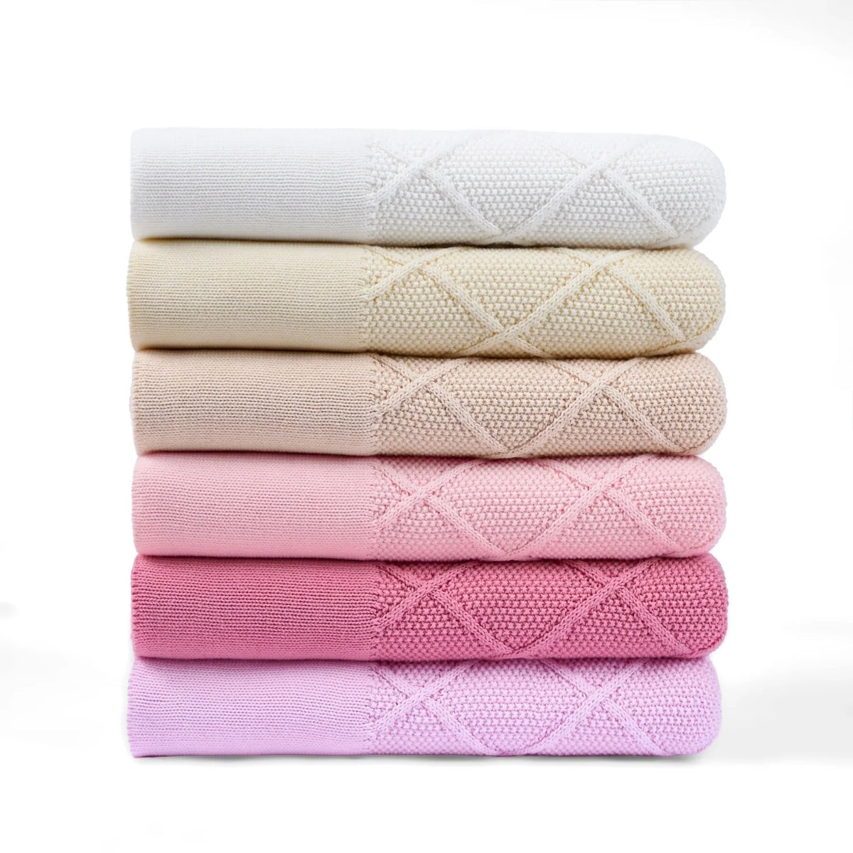 Stack of diamond-stitch baby knit blankets in pink and neutrals, folded with diamond pattern.