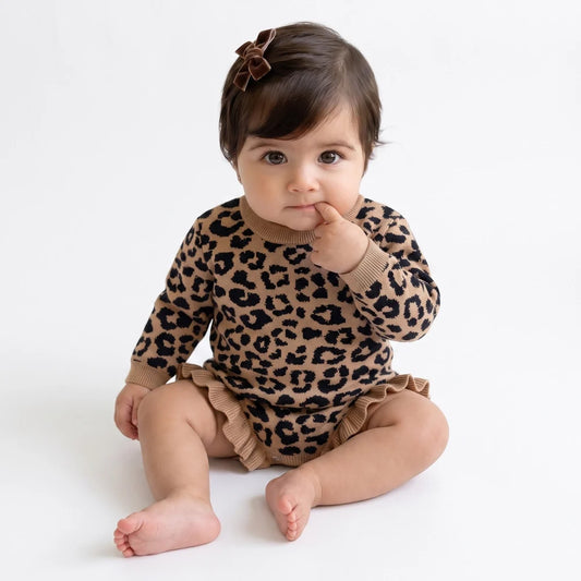 Leopard print knit romper on a baby, long sleeves with ruffle trim