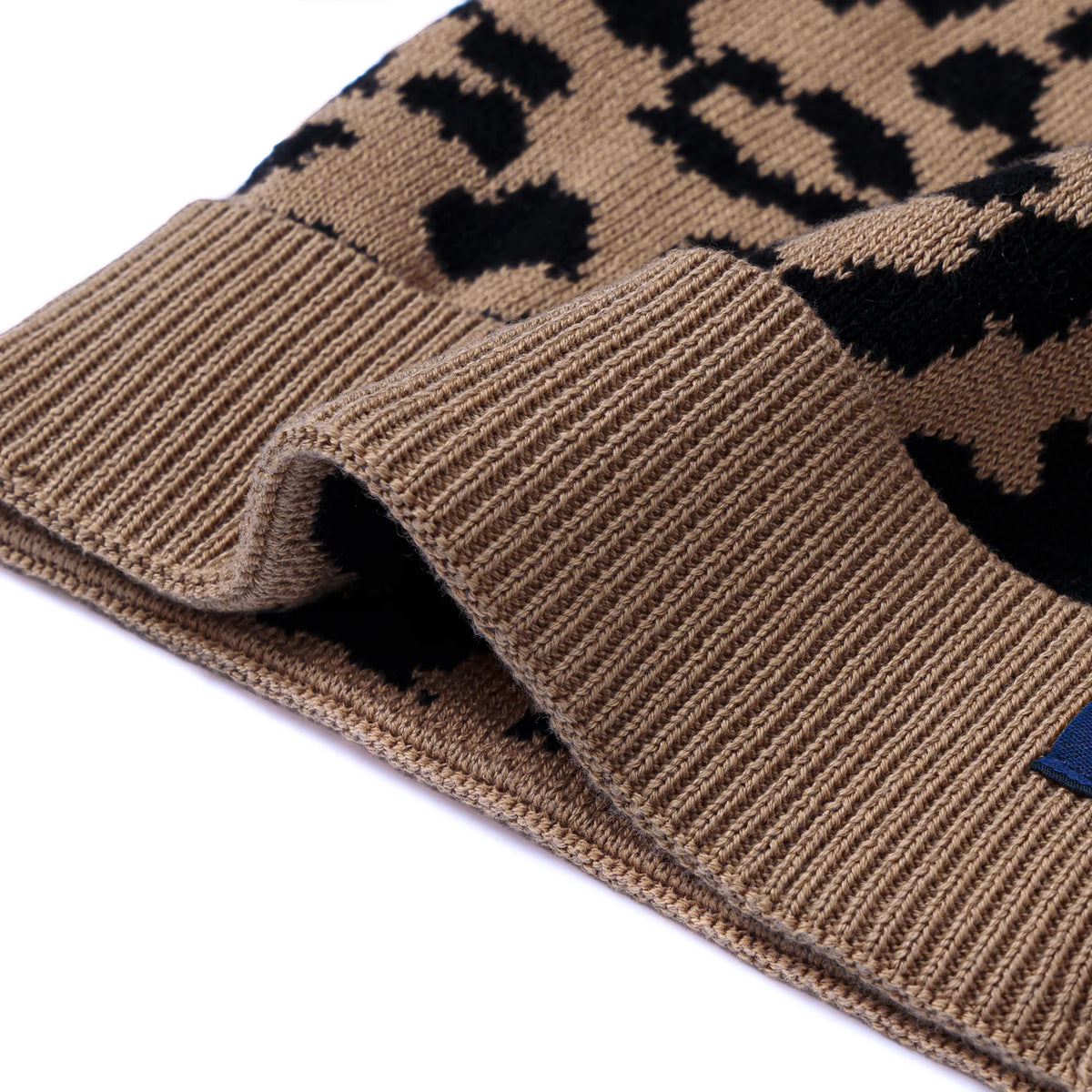 Knit beanie cuff detail with leopard pattern and ribbed knit texture