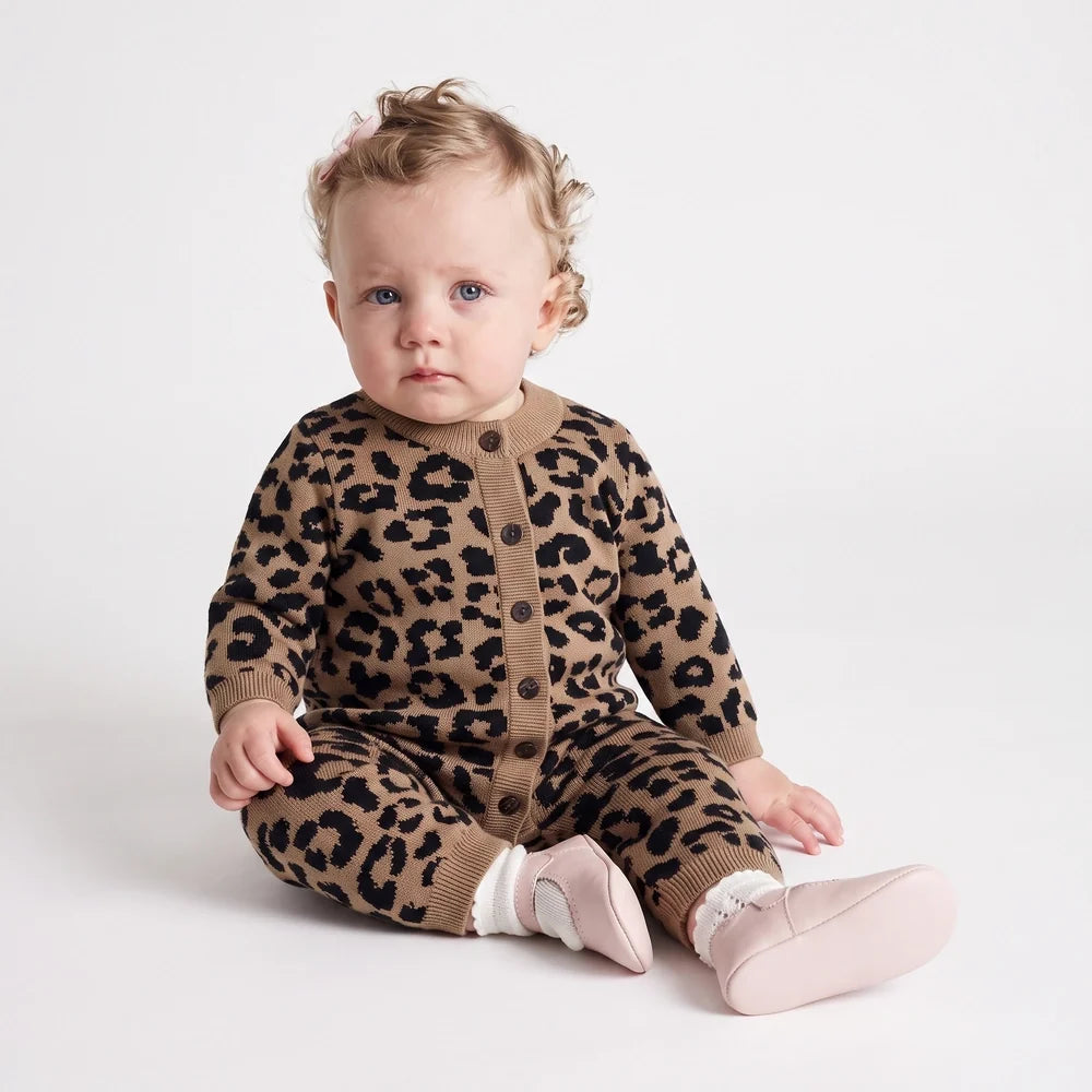 Leopard knit baby romper with front buttons and ribbed cuffs