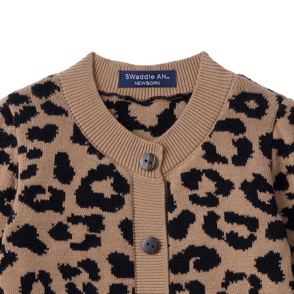 Leopard knit romper with crew neck and button placket detail