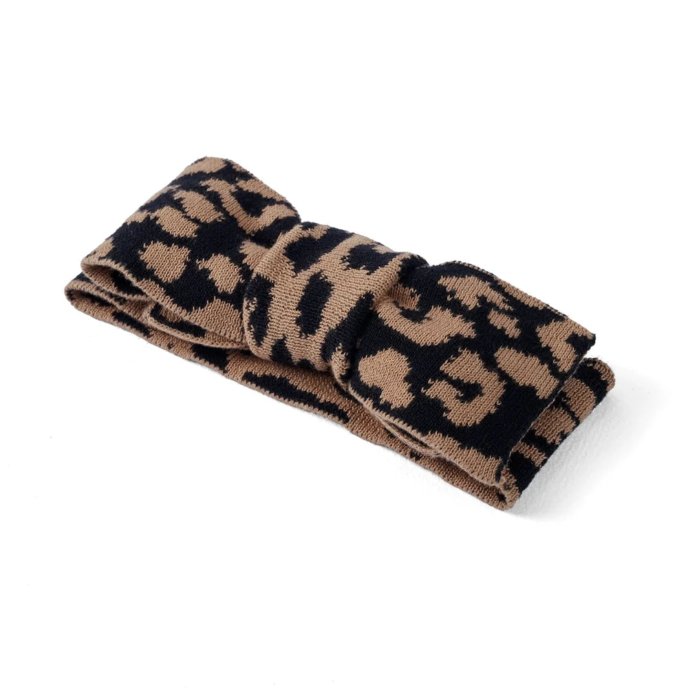 Leopard knitted topknot bow headband, folded side view with wide band