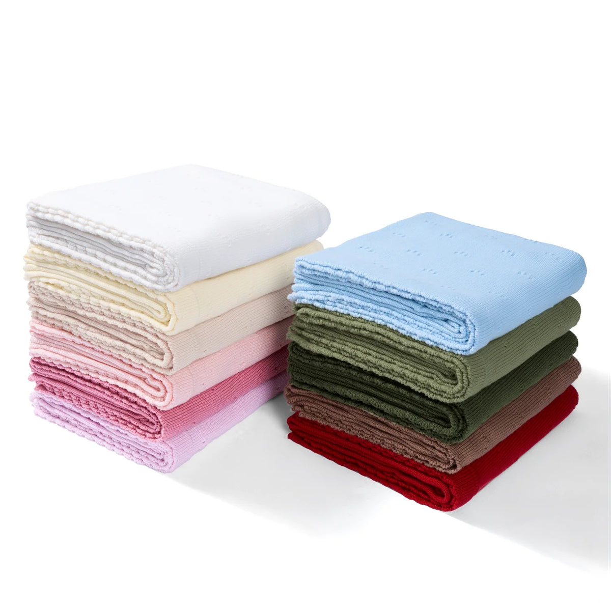 Baby knit blankets assortment, stacked folded pointelle styles in mixed colors.