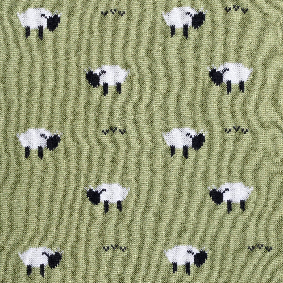 Close-up of kids olive green sweater knit with white sheep pattern