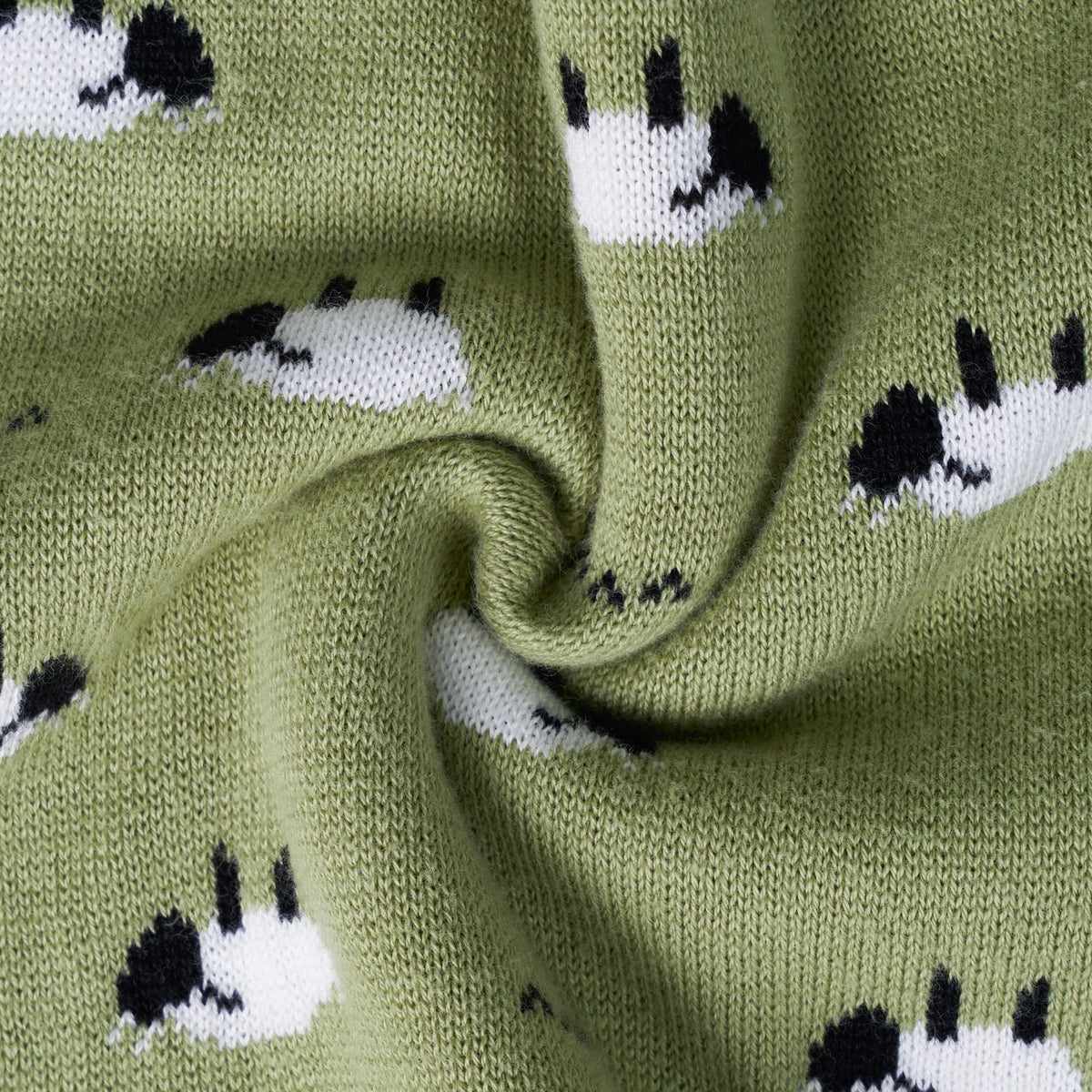 Close-up fabric view of kids olive green knit sweater with white sheep motif