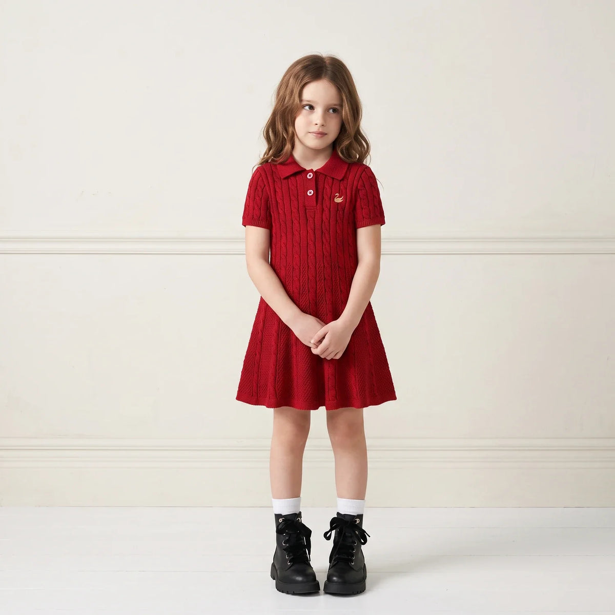 Red cable-knit polo dress with short sleeves and A-line skirt on child model