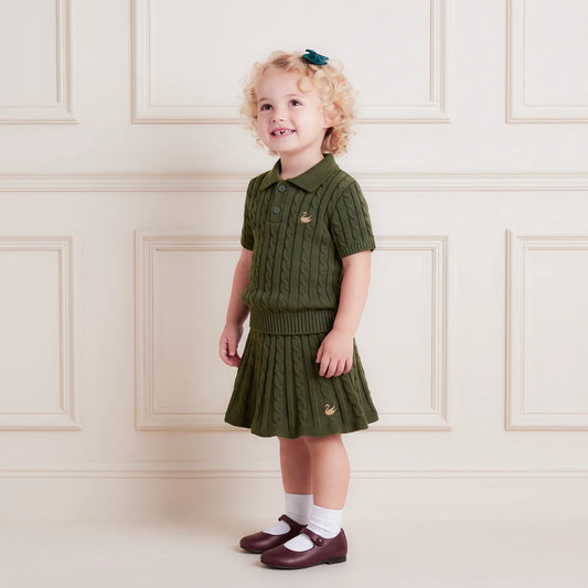Forest green cable-knit polo sweater worn by child, ribbed collar and short sleeves
