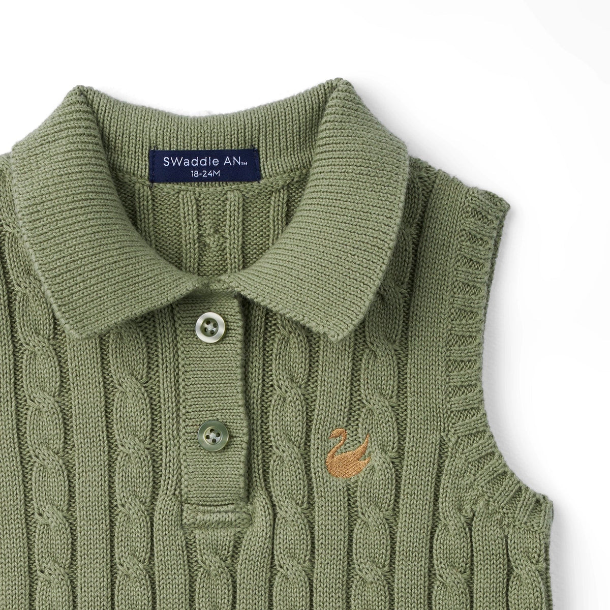 Sage green cable-knit polo shirt close-up with two button placket and small chest graphic.