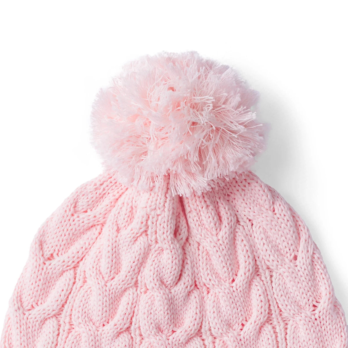 Pink cable-knit pom beanie with large fuzzy pom and cable knit texture