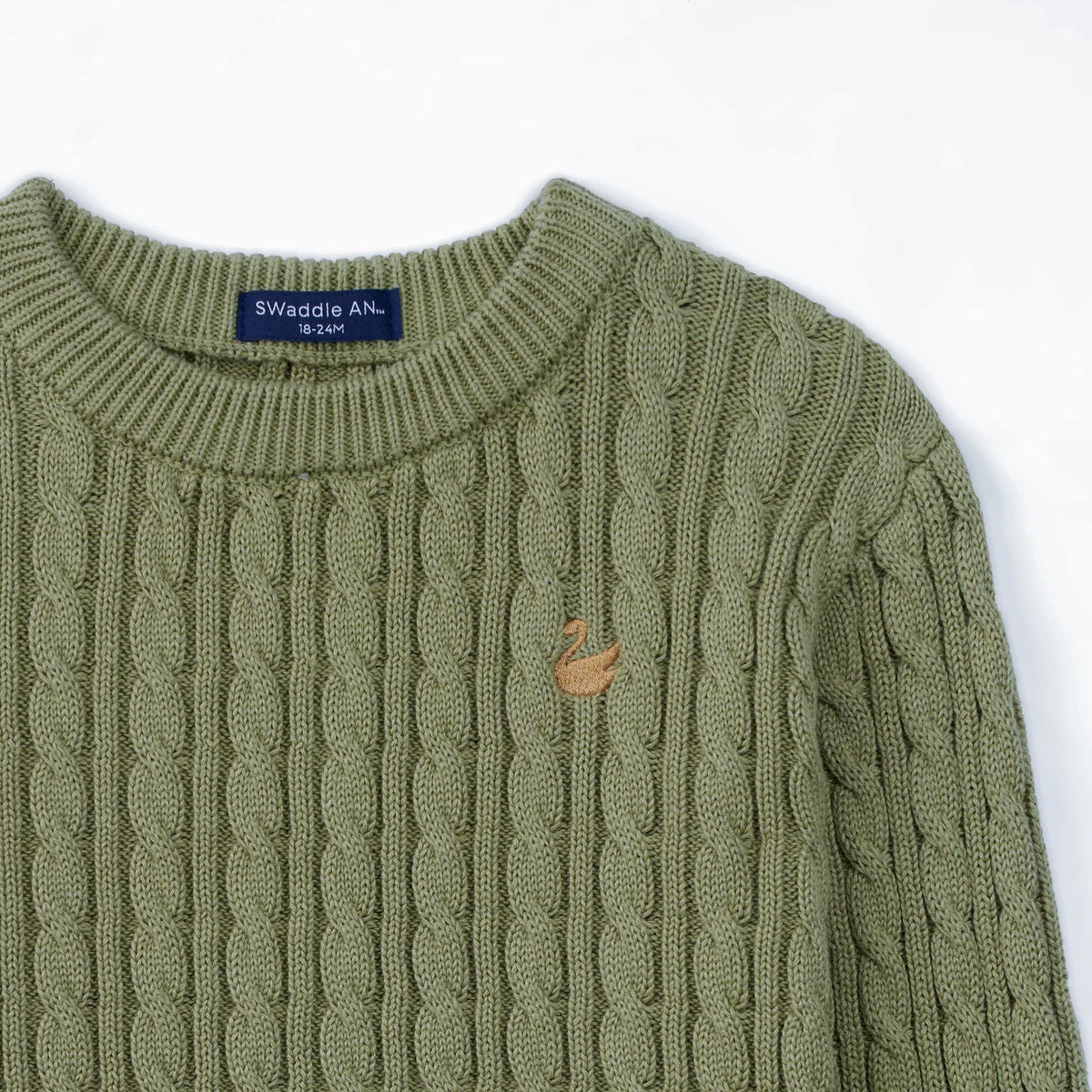 Sage green cable knit baby sweater with small embroidered logo on the chest