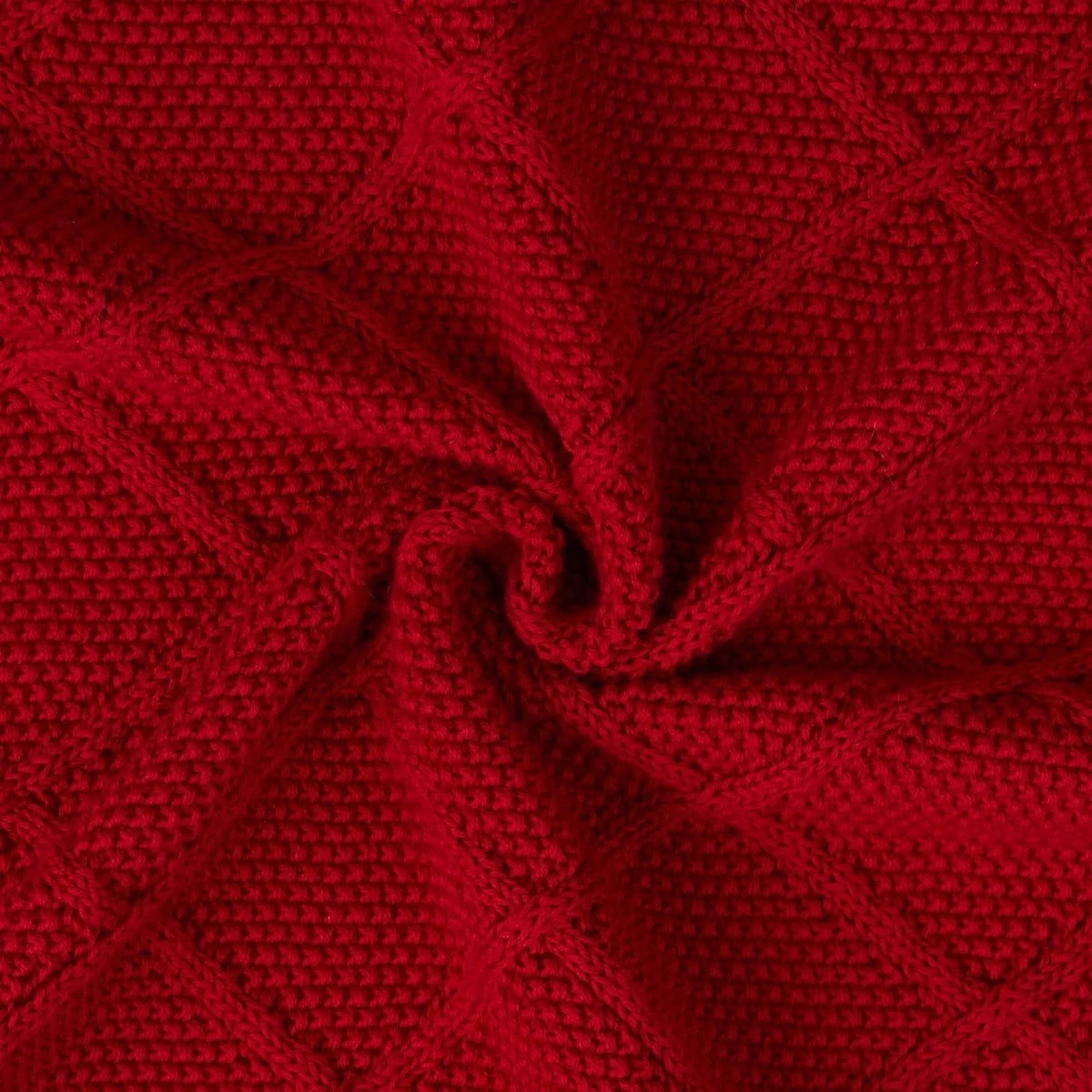 Red diamond-stitch knit blanket close-up with raised grid pattern