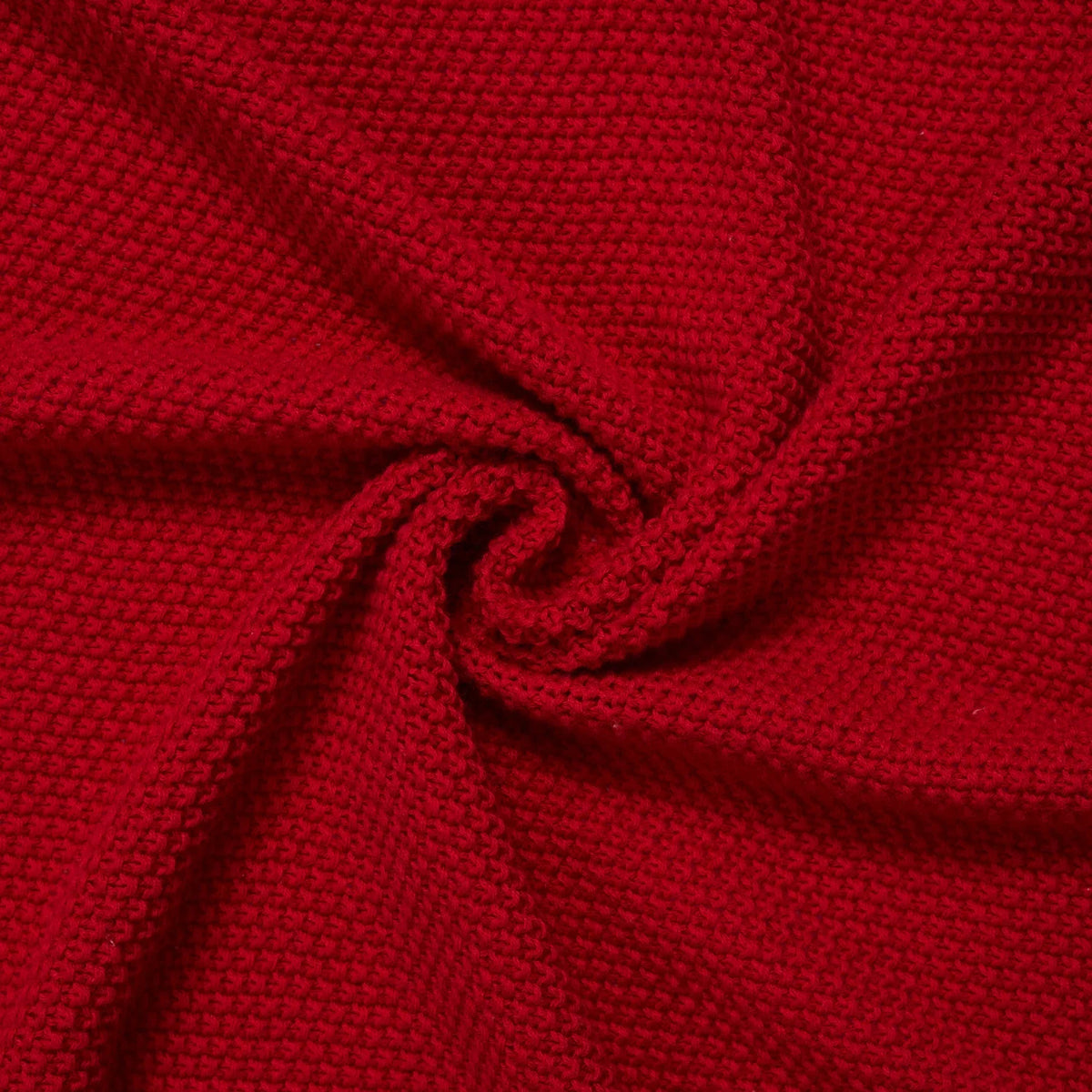 Red knit baby blanket fabric detail with braided texture and gathered edge