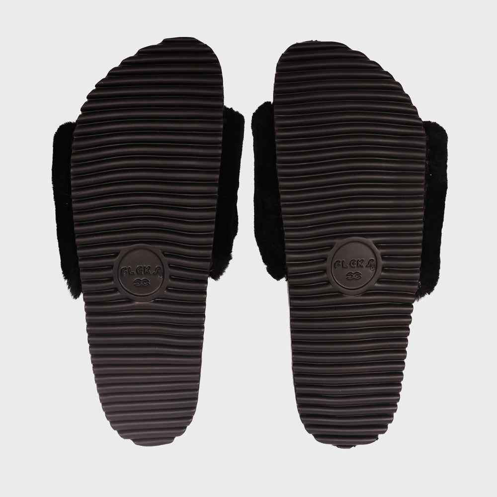Black ribbed rubber outsoles with traction grooves for slide sandals