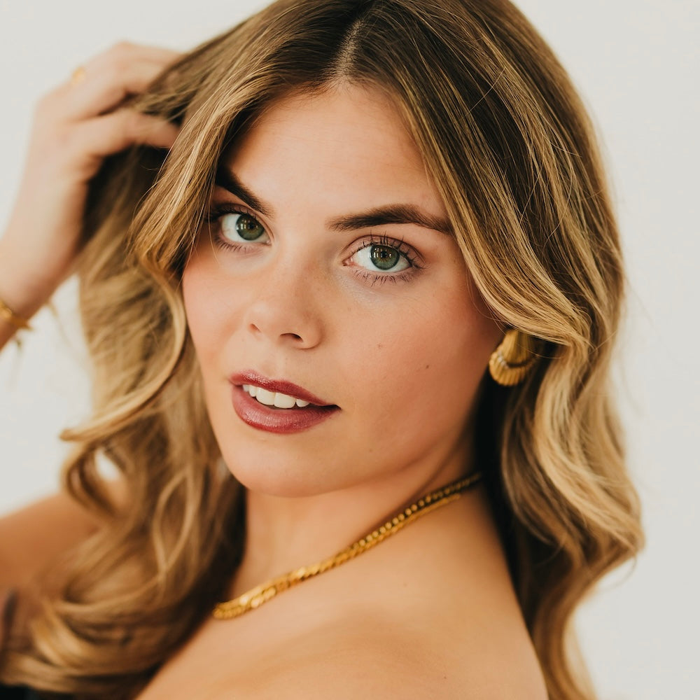 Gold shell hoop earrings with ridged scallop texture