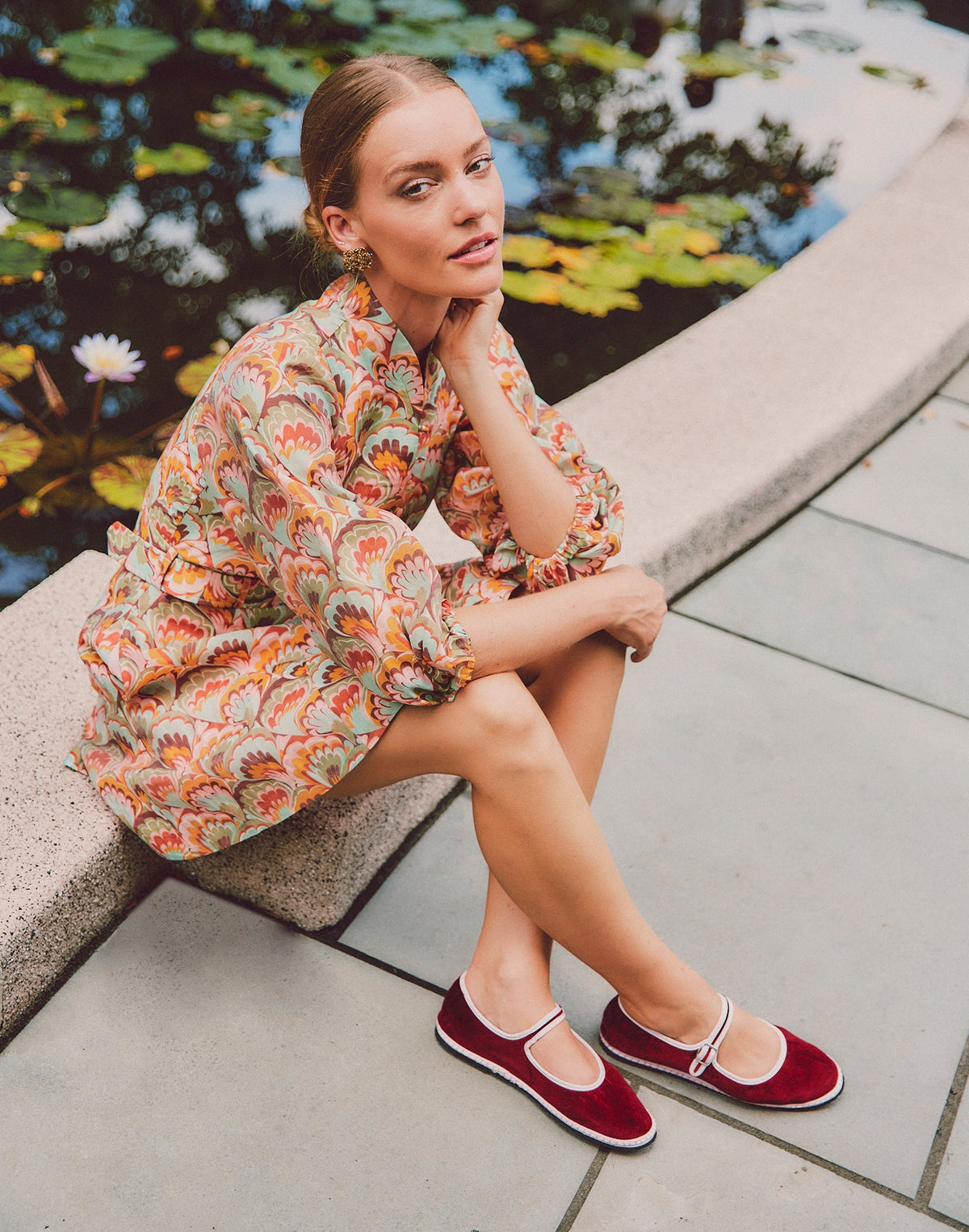 Bordeaux Mary Jane flats with white trim and ankle strap, worn