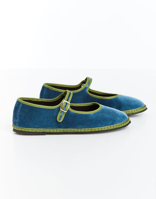 Blue Mary Jane shoes with green trim and buckled strap, angled side view