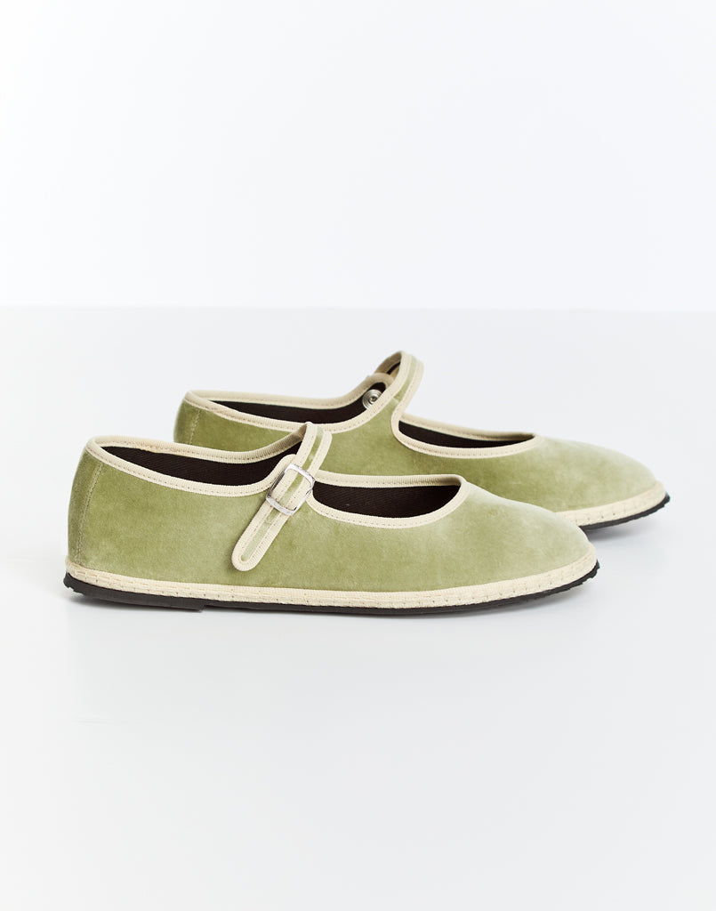 Sage green Mary Jane flats with lace-up style strap and contrast white trim