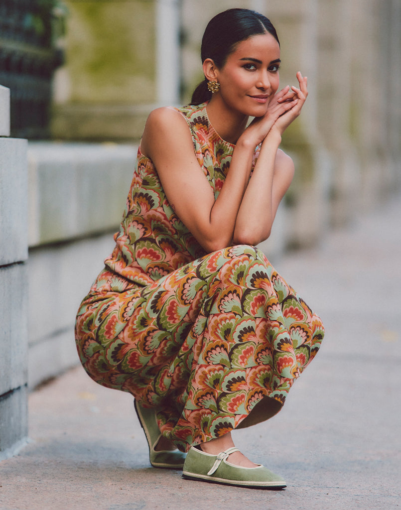 Sage green suede Mary Jane flats worn with a patterned maxi dress