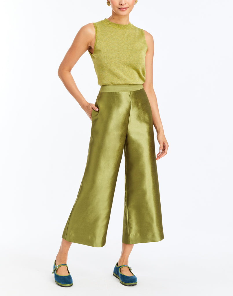 Green sleeveless wide-leg outfit with green-trim Mary Jane shoes, full-body view