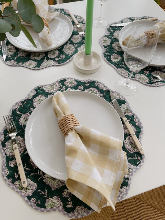 Emerald floral scalloped placemat set beneath a dinner plate