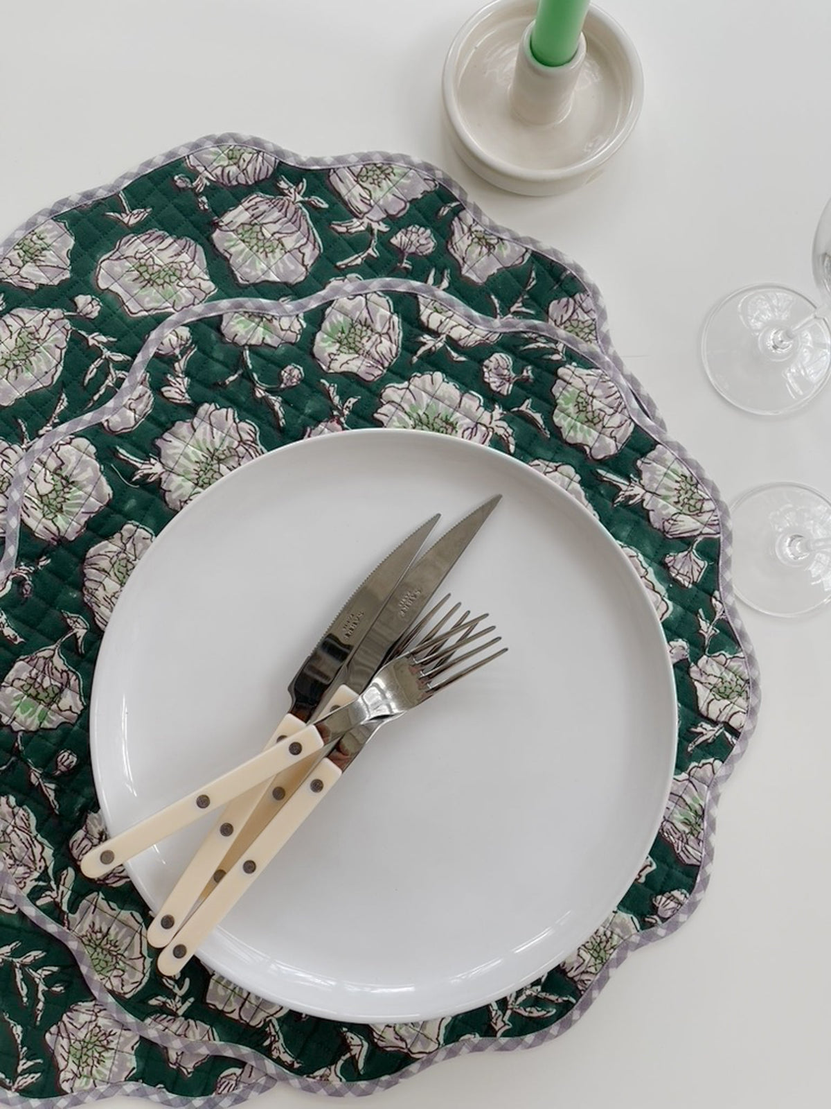 Emerald floral placemat with scalloped edge, quilted stitching, and pale poppy print