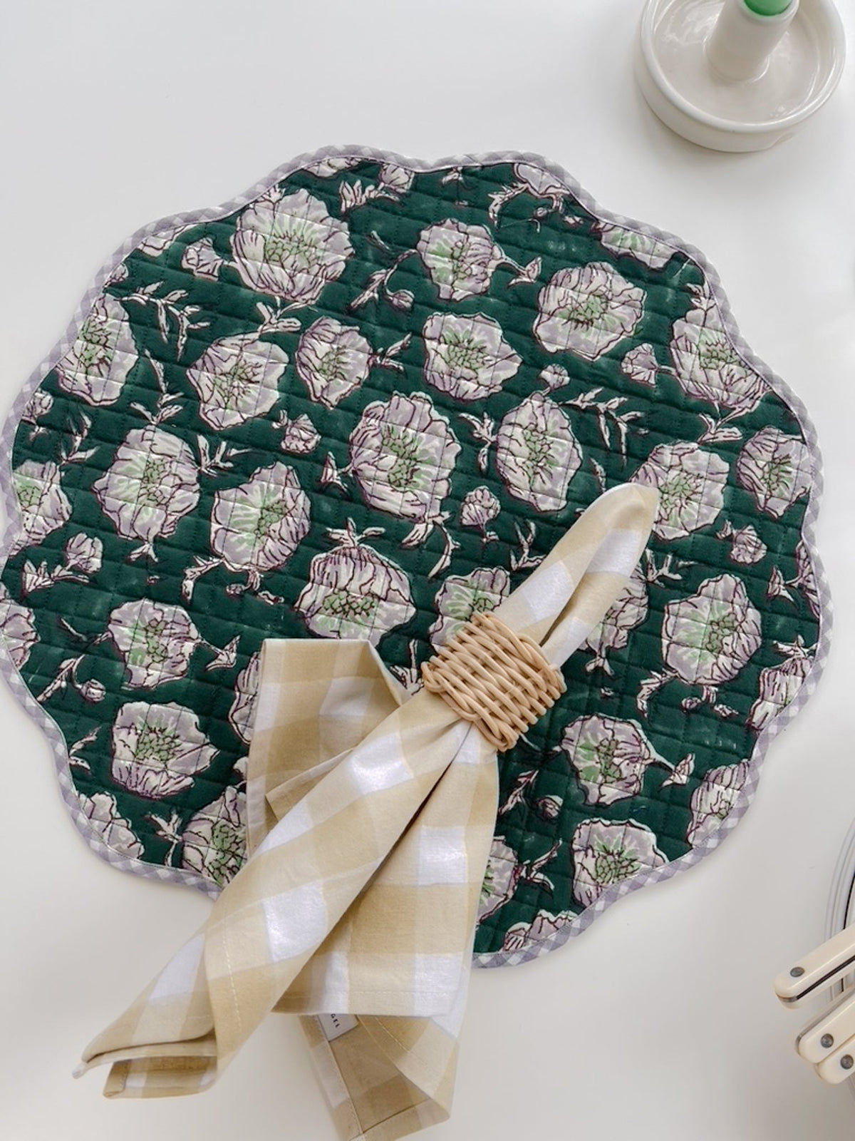 Quilted emerald placemat with scalloped trim and pale floral print