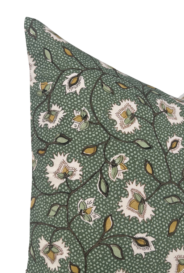 Close-up of emerald floral pillow cover fabric with cream flowers and brown stems