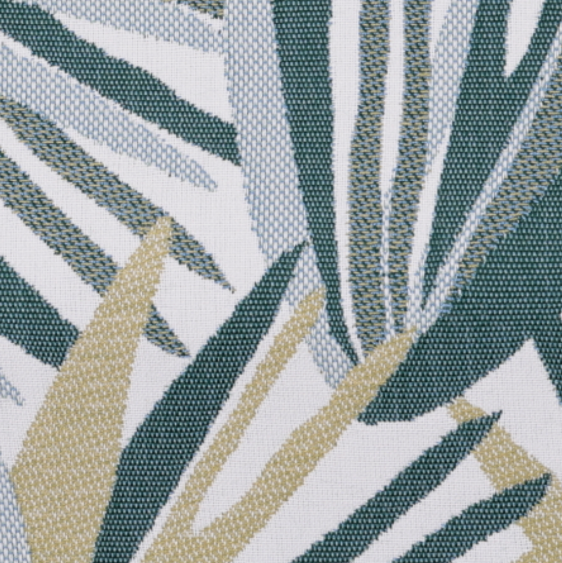 Fabric close-up of tropical leaf print with teal stripes and cream accents on a light base.